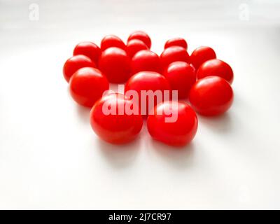 Red cherry tomatoes on white background. Top view. Stock Photo