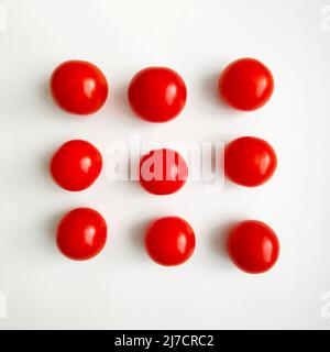 Red cherry tomatoes on white background. Top view. Stock Photo