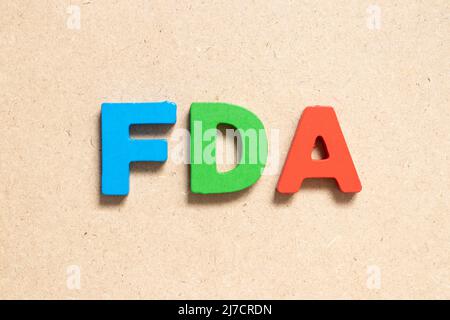 Color alphabet letter in word FDA (abbreviation of food and drug administration) on wood background Stock Photo