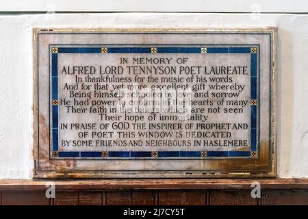 Plaque under the stained glass window in memory of poet Lord Tennyson in St Bartholomew's Church, Haslemere, England, UK Stock Photo