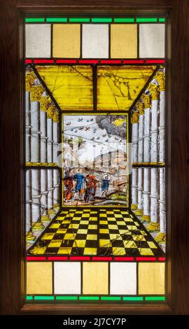 17th century Flemish painted glass, collection of paintings set into a wooden cabinet in St Bartholomew's Church, Haslemere, Surrey, England, UK Stock Photo