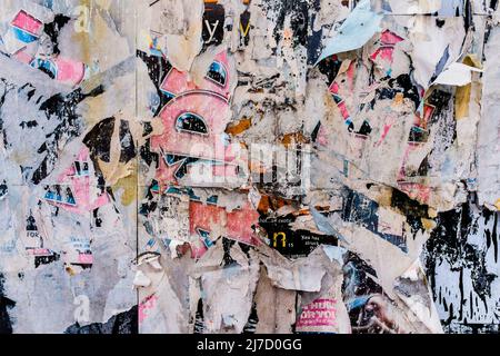 Torn posters creating a décollage effect, London, UK. Stock Photo