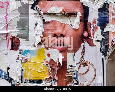Torn posters creating a décollage effect, London, UK. Stock Photo