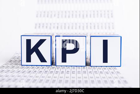 Key performance indicators. KPI letters at cubes and documents with statistics. Evaluation of business objectives achievement. Strategic planning. High quality photo Stock Photo