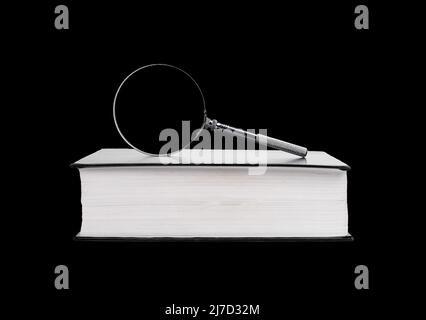 Book with magnifying glass on black background. Information retrieval. Preparing for research project. High quality photo Stock Photo