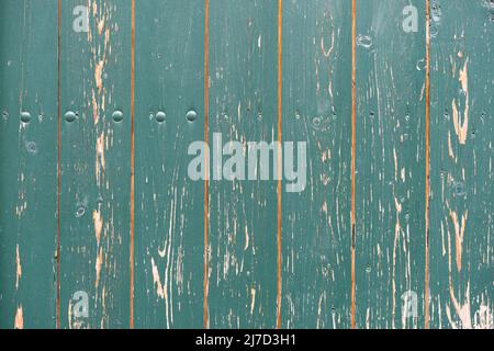 Turquoise painted timber planks background. Vertical mounted wooden boards as a building exterior. Architectural backdrop with a natural texture. Stock Photo