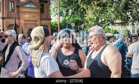 Seville, Spain; April 15, 2022: Three bearers (costaleros in spanish) of the brotherhood 'El Cachorro' during the Holy Week. Good Friday. Stock Photo