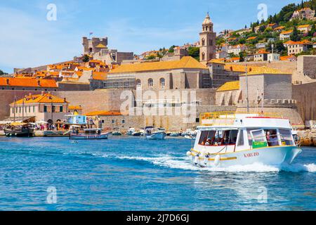 Dubrovnik, Croatia - Jine 12, 2017: Small ferry boat by the Old Town of Dubrovnik Stock Photo