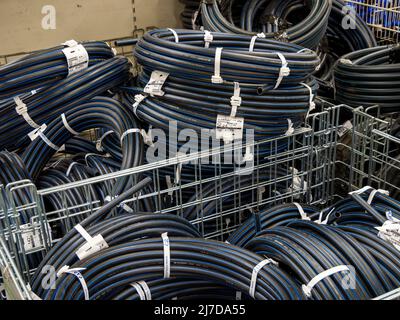 Voronezh, Russia - July 11, 2021: HDPE pipes for water lie in the containers of the store Stock Photo