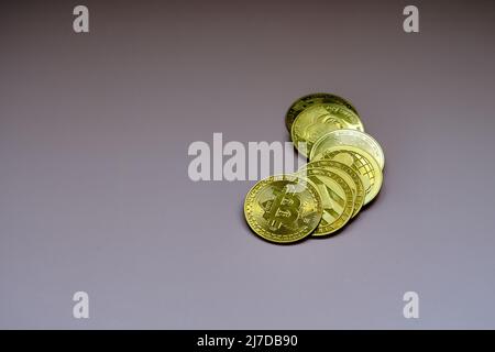 Top view of a pile of bitcoins on a purple table. Stock Photo