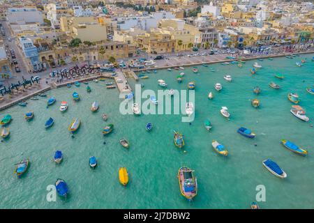 Aerial panoramic view of Marsaxlokk - small, traditional fishing village in the South Eastern Region of Malta with many colorful fisherman boats Stock Photo