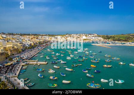 Aerial panoramic view of Marsaxlokk - small, traditional fishing village in the South Eastern Region of Malta with many colorful fisherman boats Stock Photo