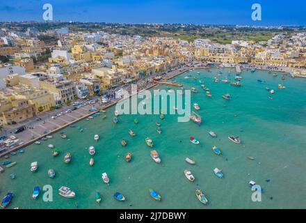 Aerial panoramic view of Marsaxlokk - small, traditional fishing village in the South Eastern Region of Malta with many colorful fisherman boats Stock Photo