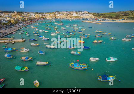 Aerial panoramic view of Marsaxlokk - small, traditional fishing village in the South Eastern Region of Malta with many colorful fisherman boats Stock Photo