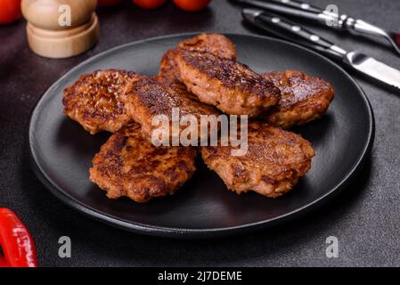Fried cutlets of minced fish on serving board. View from above Stock Photo