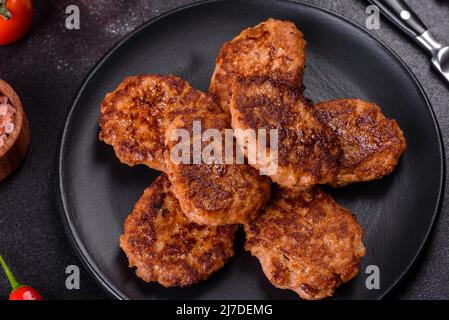 Fried cutlets of minced fish on serving board. View from above Stock Photo