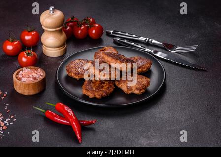 Fried cutlets of minced fish on serving board. View from above Stock Photo
