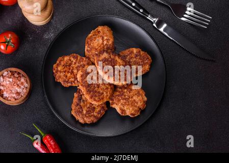 Fried cutlets of minced fish on serving board. View from above Stock Photo