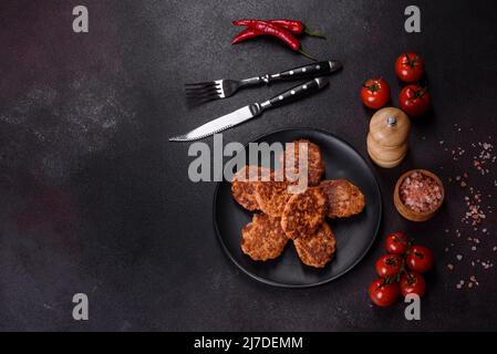 Fried cutlets of minced fish on serving board. View from above Stock Photo