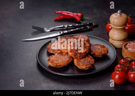 Fried cutlets of minced fish on serving board. View from above Stock Photo