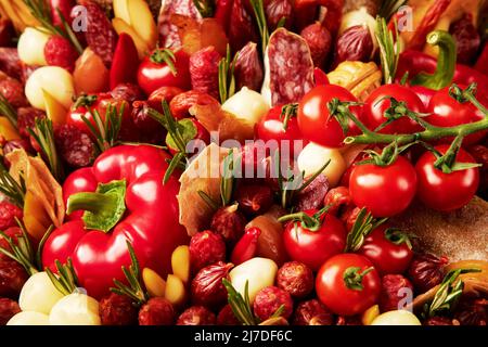Bouquet of sausage of different types, cheese, bread and tomatoes, decorated with rosemary and pepper close-up Stock Photo