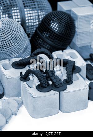 Many different models printed on 3D printer. Gray and black objects printed Stock Photo