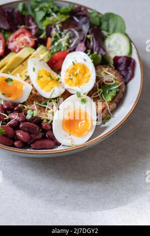Medium boiled eggs with sasld, healthy breakfast Stock Photo