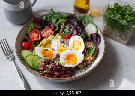Medium boiled eggs with sasld, healthy breakfast Stock Photo