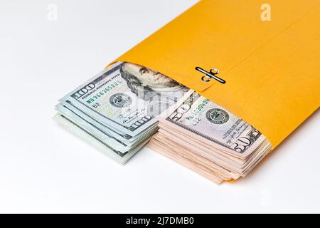 Cash money in envelope isolated on white background. Bribe, crime and corruption concept. Stock Photo