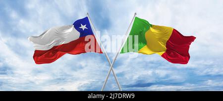 Chile and Mali flag waving in the wind against white cloudy blue sky ...