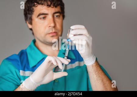 Doctor, nurse, scientist hand in blue gloves holding flu, measles, coronavirus, covid-19 disease vaccine  Stock Photo