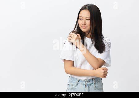 Suffering from neuralgia after sleeping in wrong position tanned beautiful young Asian woman touching painful shoulder isolated at white background Stock Photo