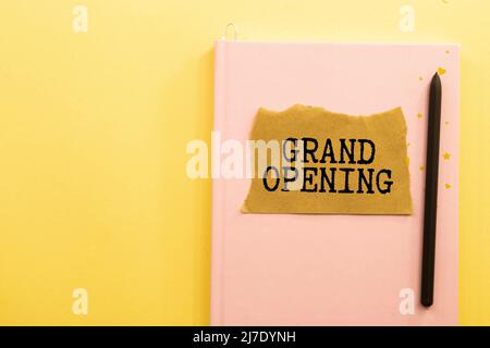Text message GRAND OPENING on brown torn paper with black backdrop Stock Photo