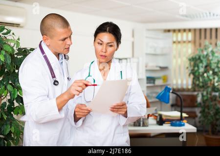 Two doctors discussing about medical report Stock Photo