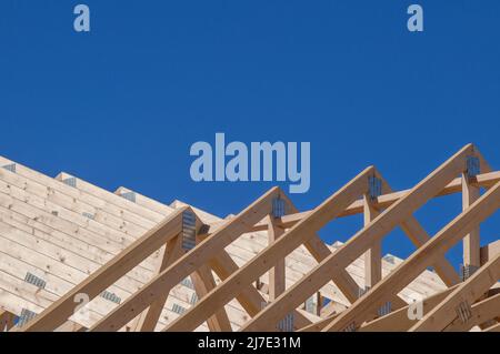 Roof trusses and rafters in new housing construction Stock Photo
