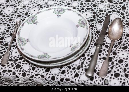 Vintage spoon knife fork and plate . Service size utensils Stock Photo