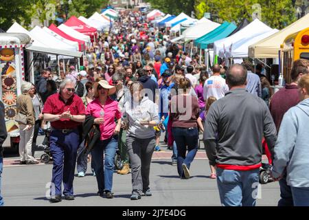 People walk past vendor booths during the 36th annual Spring Fling in Danville, Pennsylvania, on May 8, 2022. The street festival features about 200 food and craft vendors in booths along Mill Street. (Photo by Paul Weaver/Sipa USA) Stock Photo