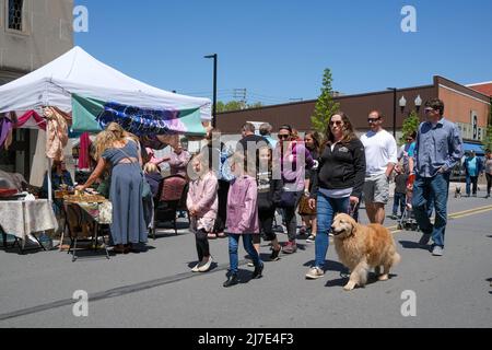 People walk past vendor booths during the 36th annual Spring Fling in Danville, Pennsylvania, on May 8, 2022. The street festival features about 200 food and craft vendors in booths along Mill Street. (Photo by Paul Weaver/Sipa USA) Stock Photo