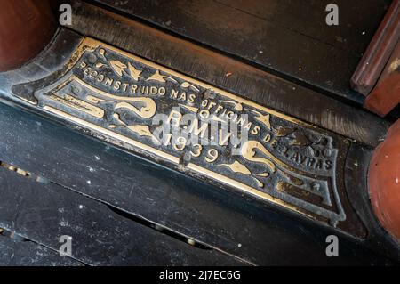 A metal plate at the door of one of the touristic steam train passenger cars saying 'Rebuilt at Lavras workshops' in the year of 1939. Stock Photo