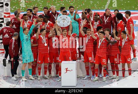 MUNICH, May 9, 2022 (Xinhua) -- Bayern Munich's members celebrate with the trophy during the awarding ceremony for winning the title of German first division Bundesliga football match in Munich, Germany, May 8, 2022. (Photo by Philippe Ruiz/Xinhua) Stock Photo