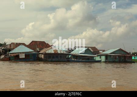 Floating houses on river Musi in Palembang, South Sumatra, Indonesia. In Srivijaya times, there were many citizens lived on floating houses along the river. I-Tsing (Yijing), a 7th century Chinese monk who travelled the maritime silk road to reach India to learn Buddhism, wrote on his notes that the sail from present day Guangzhou took 20 days, before 'the ship reached the capital of Srivijaya), where I landed and stayed six months, gradually learning the Sabdavidya (Sanskrit grammar).' Stock Photo