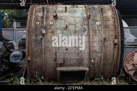 Antique old large wooden barrels for the tanning of cattle leather was left to deteriorate over time. The barrels are made of hardwood. Selective focu Stock Photo