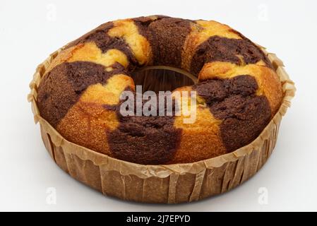 Bicolor cake on a baking sheet isolated on white background. Stock Photo