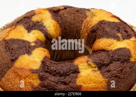Bicolor cake on a baking sheet isolated on white background. Close-up Stock Photo