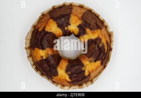 Bicolor cake on a baking sheet isolated on white background. Top view Stock Photo