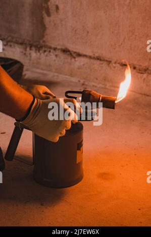 Man Using Blowtorch Gasoline blowtorch with a burning fire, the use of a blowtorch in ...