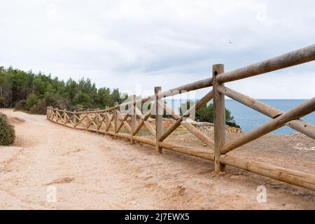 Fence near the rock arch in Portugal. Landscape of Praia da Marinha in Algarve region, Portugal. Stock Photo