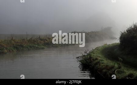 Travelling along the Trent and Mersey canal aboard the narrow boat “Emma Maye” aka The Wool Boat on a misty autumn morning in Cheshire. Stock Photo