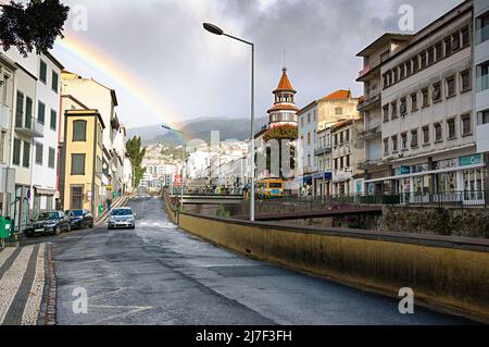 FUNCHAL, MADEIRA ISLAND - February 20, 2022: Funchal city street after the rain with a beautiful rainbow Stock Photo