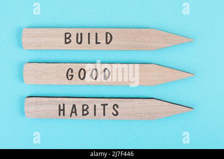 The words build good habits are standing on arrows, change lifestyle, healthy and positive attidude, motivation concept Stock Photo